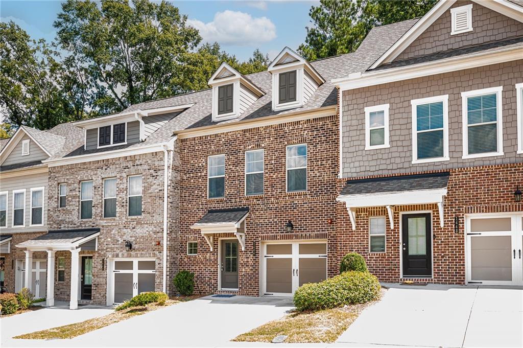 1444 Ridgebend Way Southeast Mableton, GA 30126 - Photo 2 of 34 a front view of a building with a garden