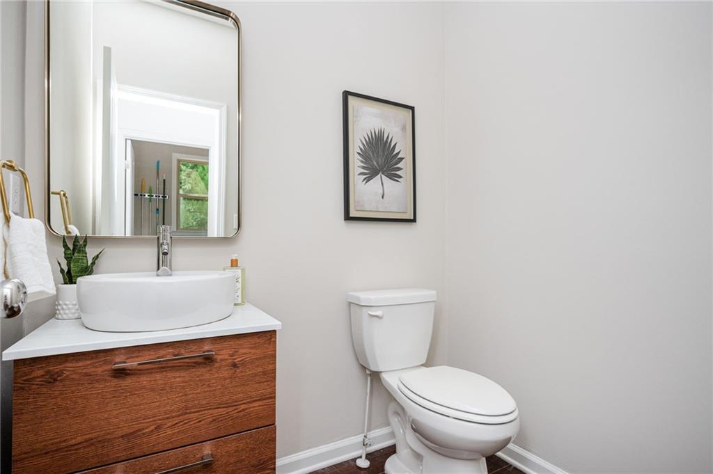 1444 Ridgebend Way Southeast Mableton, GA 30126 - Photo 28 of 34 a bathroom with a toilet a sink and mirror