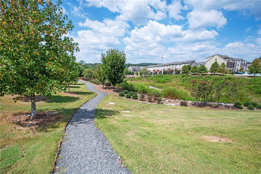 1444 Ridgebend Way Southeast Mableton, GA 30126 - Photo 32 of 34 a view of a garden with a building in the background