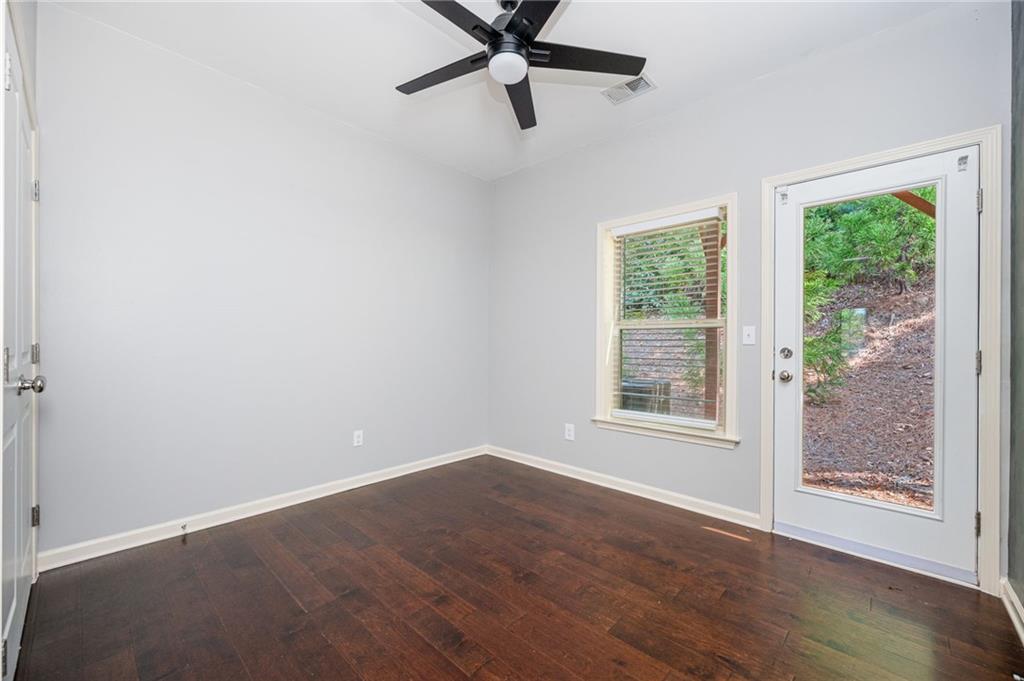 1444 Ridgebend Way Southeast Mableton, GA 30126 - Photo 8 of 34 an empty room with wooden floor fan and windows