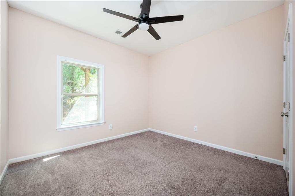 1444 Ridgebend Way Southeast Mableton, GA 30126 - Photo 9 of 34 an empty room with a window and a fan