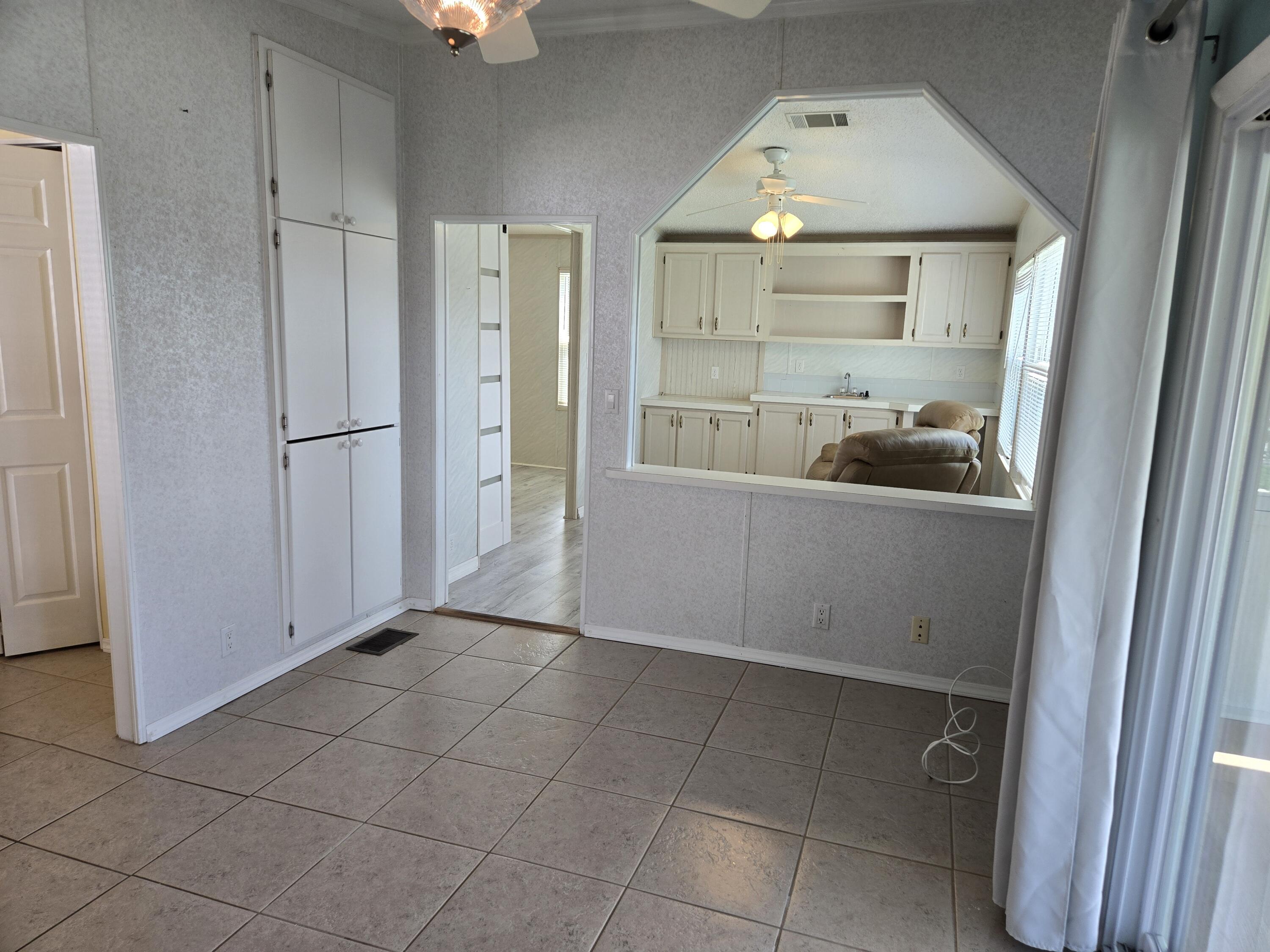 1586 Southwest 35th Circle Okeechobee, FL 34974 - Photo 15 of 37 a view of a kitchen with a sink and cabinet with wooden floor