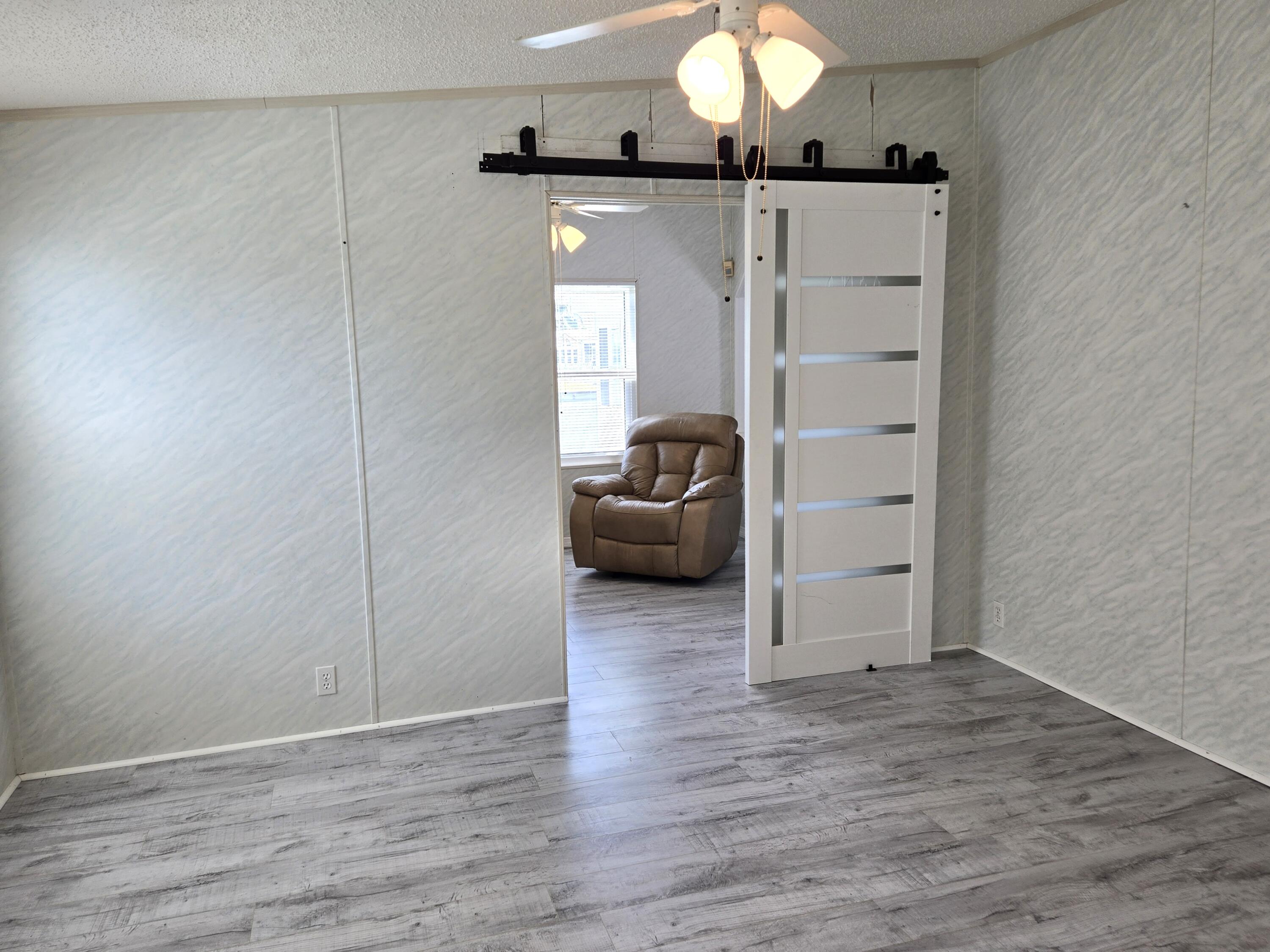 1586 Southwest 35th Circle Okeechobee, FL 34974 - Photo 16 of 37 a view of a livingroom with wooden floor