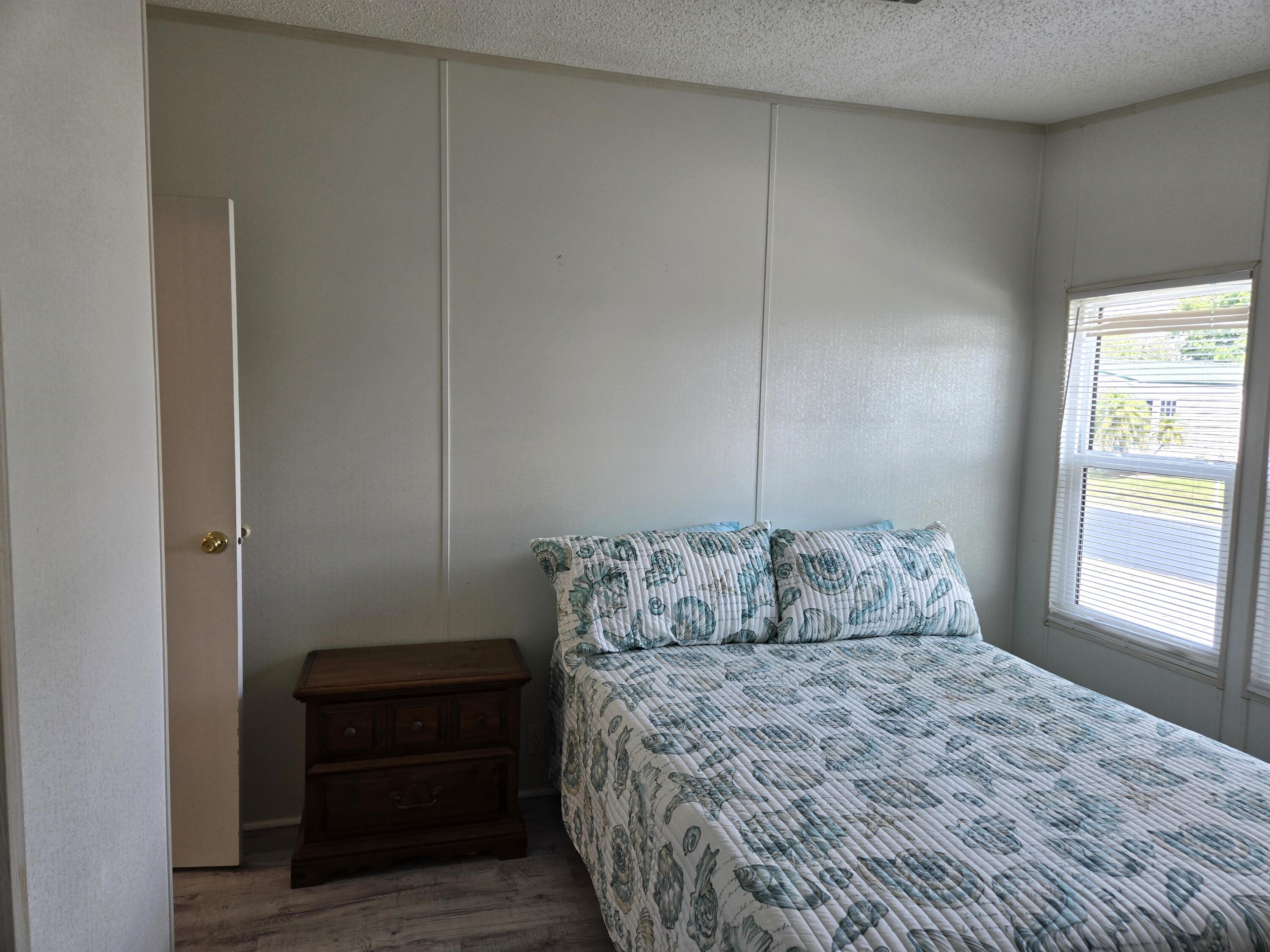 1586 Southwest 35th Circle Okeechobee, FL 34974 - Photo 22 of 37 a bedroom with a bed and a window