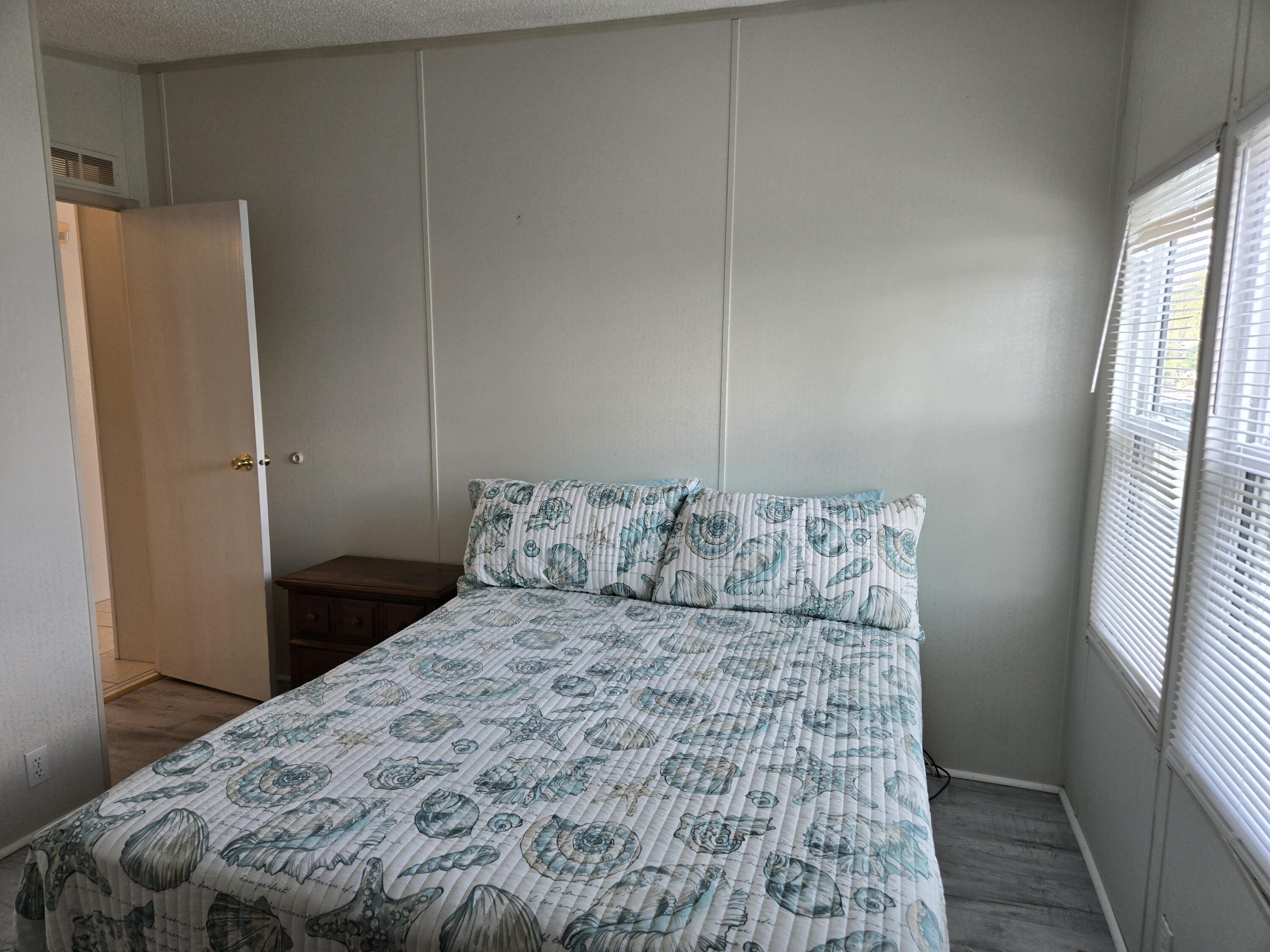 1586 Southwest 35th Circle Okeechobee, FL 34974 - Photo 23 of 37 a bed sitting in a bedroom next to a window