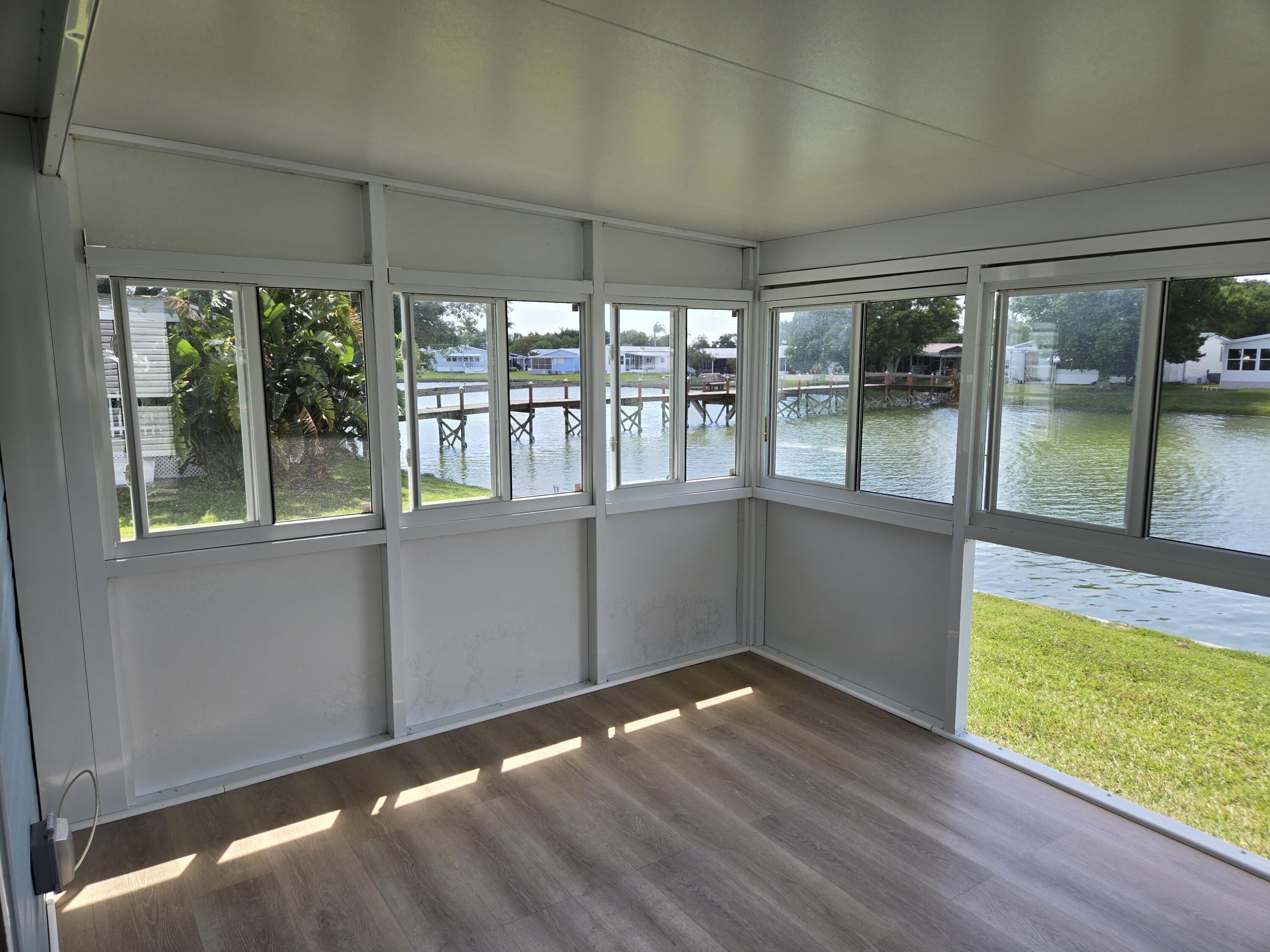 1586 Southwest 35th Circle Okeechobee, FL 34974 - Photo 29 of 37 wooden floor in an empty room with a window