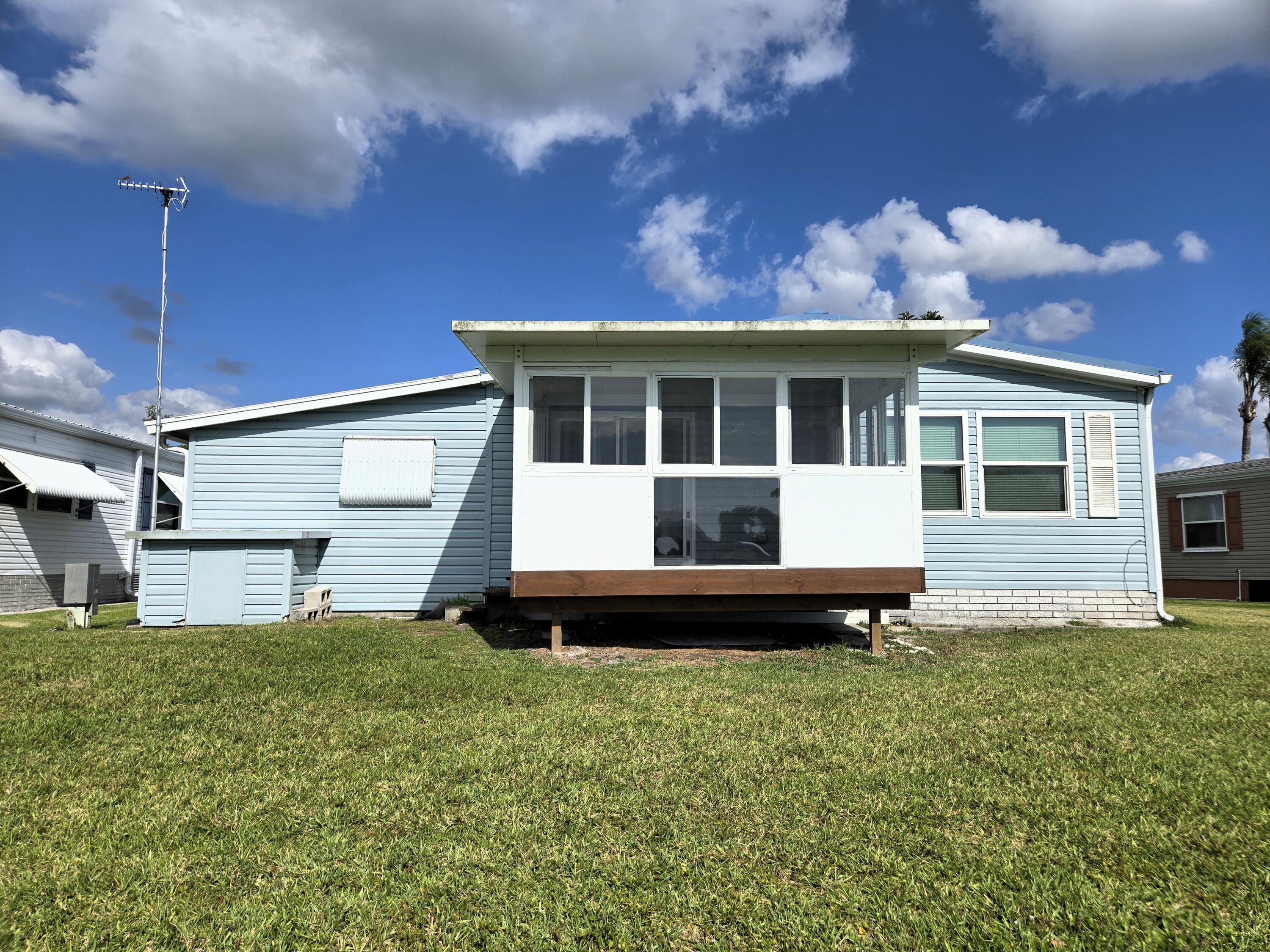 1586 Southwest 35th Circle Okeechobee, FL 34974 - Photo 37 of 37 a front view of a house with a yard