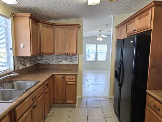 a kitchen with stainless steel appliances a stove microwave and refrigerator