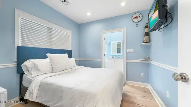 a bed room with a bed and a potted plant