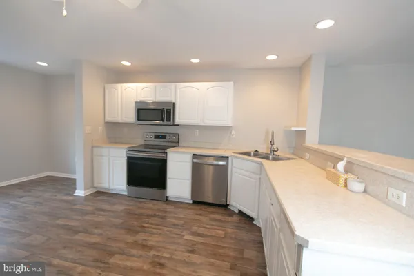 a kitchen with a sink stove and refrigerator