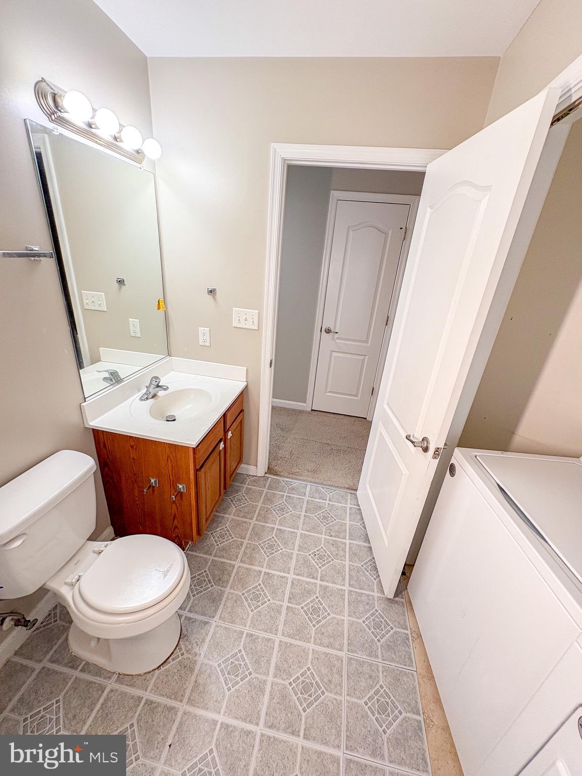 17 Ward Street Harrington, DE 19952 - Photo 21 of 34 a bathroom with a sink a toilet a mirror and vanity