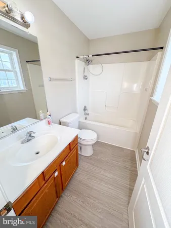 a spacious bathroom with a double vanity sink toilet and shower