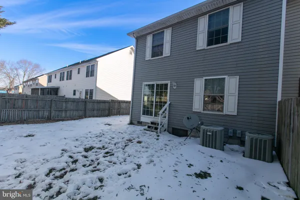 a backyard of a house with wooden fence