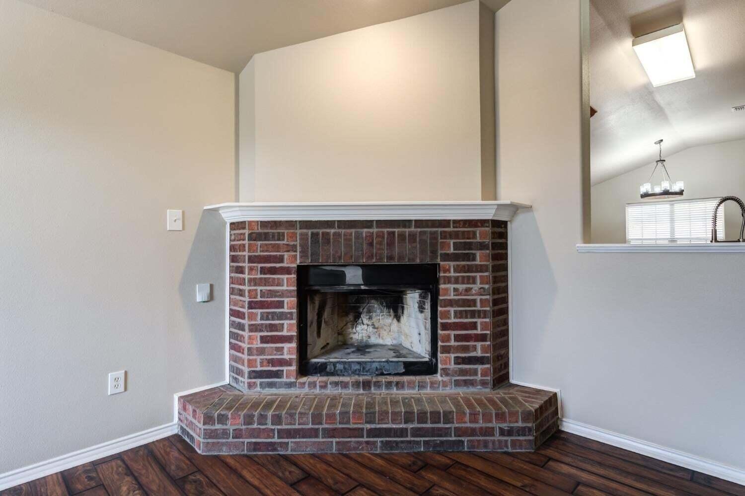 6554 92nd Street Lubbock, TX 79424 - Photo 4 of 17 a living room with furniture and a fireplace