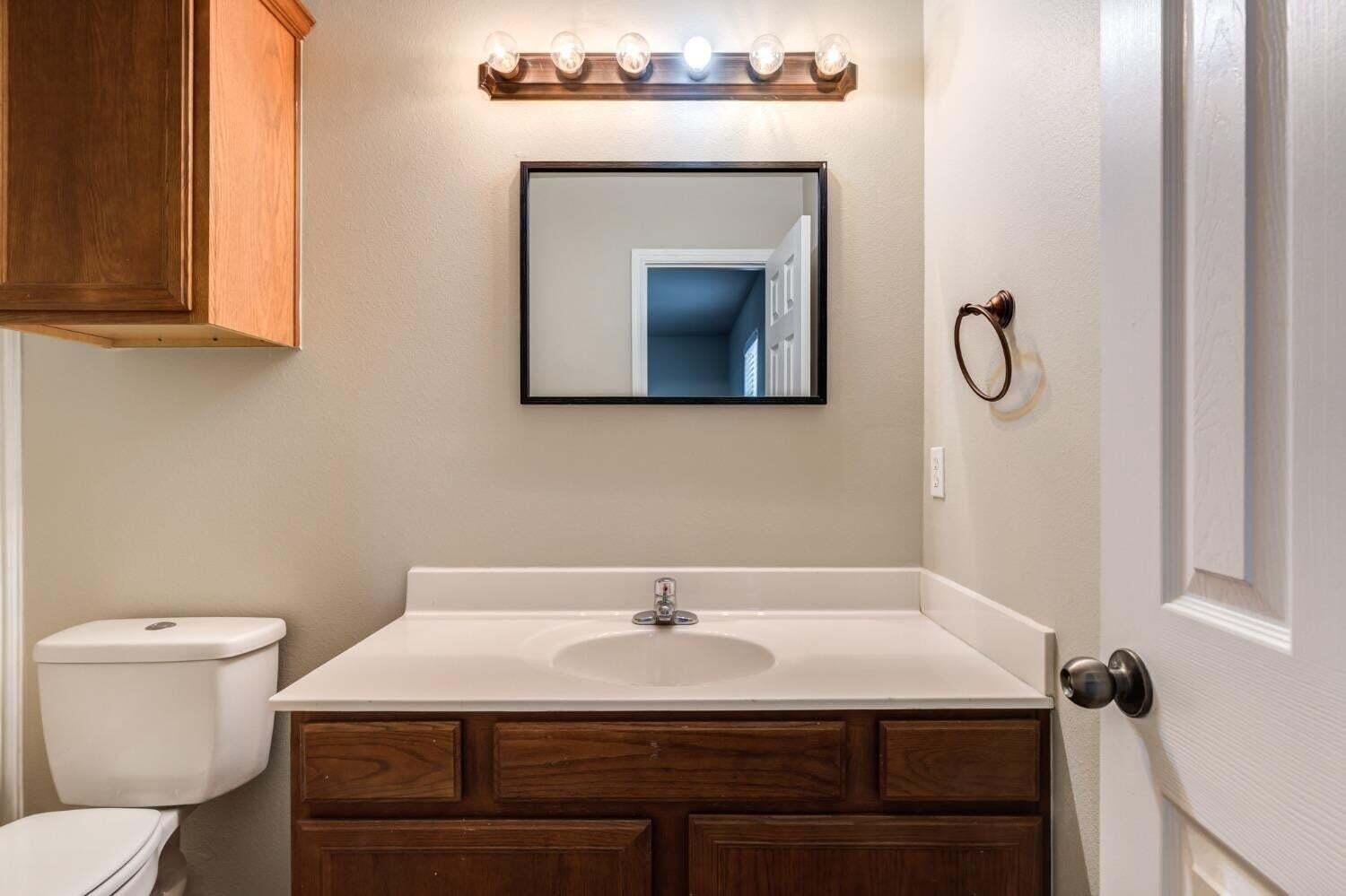 6554 92nd Street Lubbock, TX 79424 - Photo 10 of 17 a bathroom with a sink and a toilet