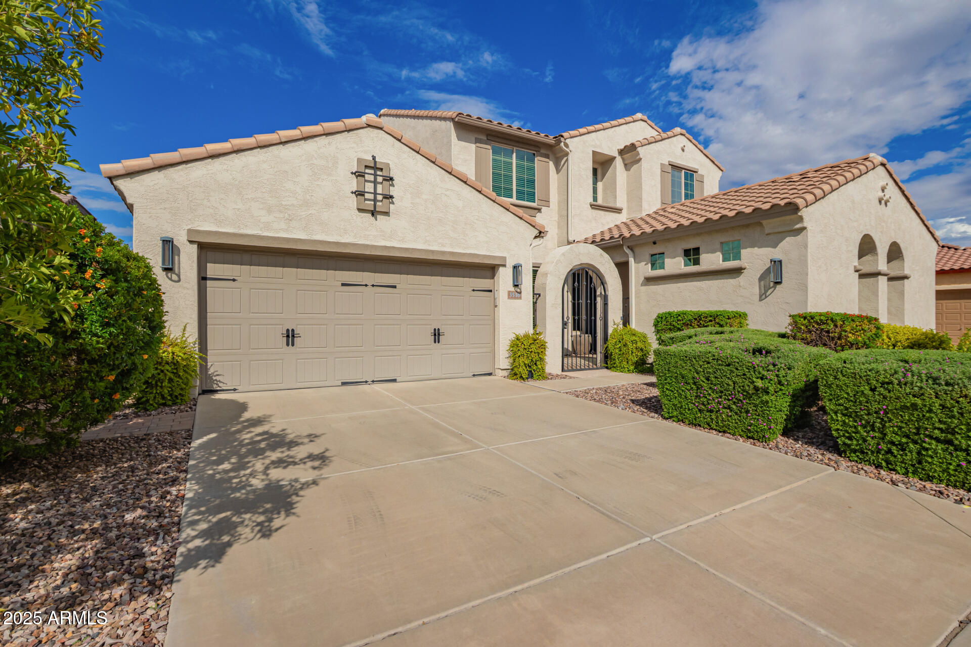 3516 East Megan Street Gilbert, AZ 85295 - Photo 1 of 60 a front view of a house with a yard and garage