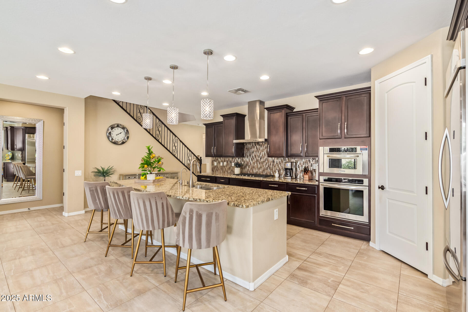 3516 East Megan Street Gilbert, AZ 85295 - Photo 18 of 60 a kitchen with stainless steel appliances granite countertop a stove top oven a sink dishwasher and a refrigerator