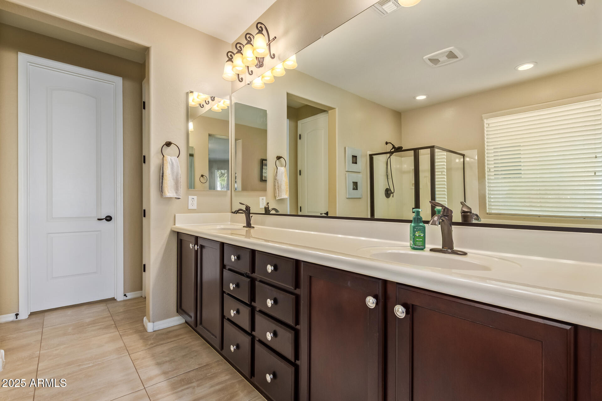 3516 East Megan Street Gilbert, AZ 85295 - Photo 24 of 60 a bathroom with a double vanity sink and a mirror