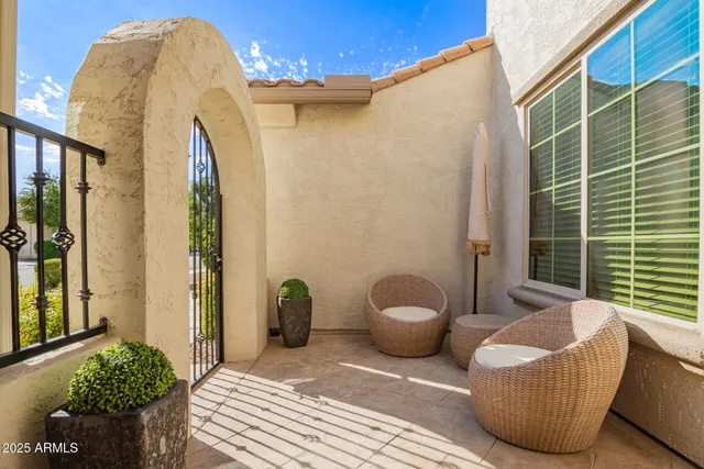 a living room with furniture and floor to ceiling window