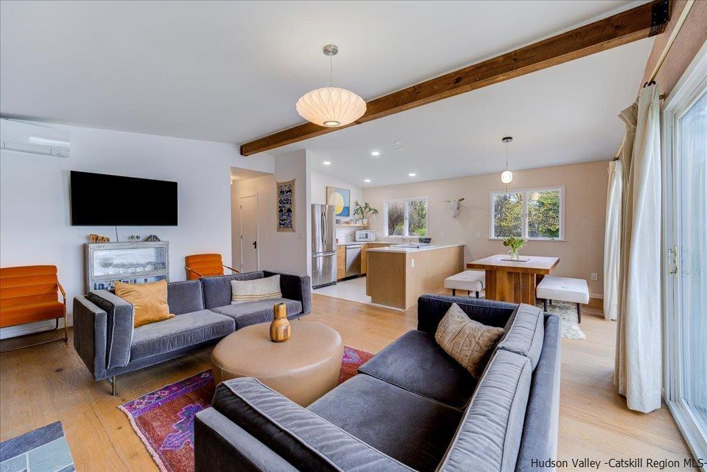 45 Duck Pond Road Stone Ridge, NY 12484 - Photo 3 of 27 a living room with furniture and a flat screen tv