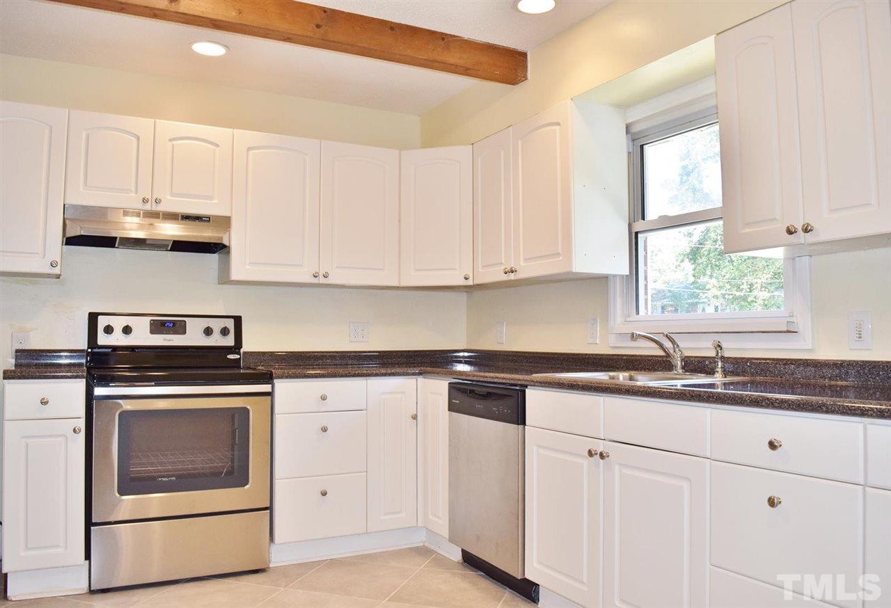 3606 Woodside Road Garner, NC 27529 - Photo 3 of 16 a kitchen with cabinets stainless steel appliances a sink and a window