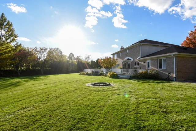 a view of a big yard with a house in the background