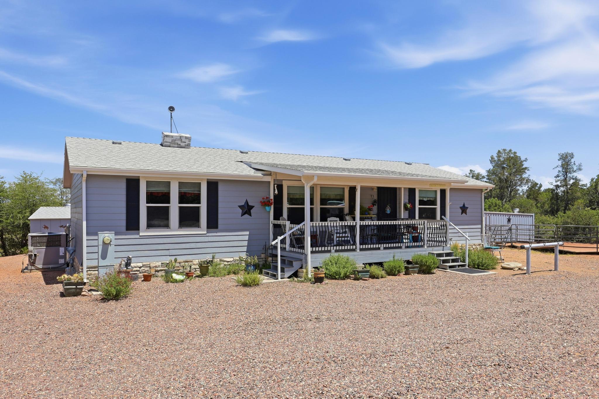1211 Heather Circle Payson, AZ 85541 - Photo 27 of 51 a front view of a house with a yard and seating space