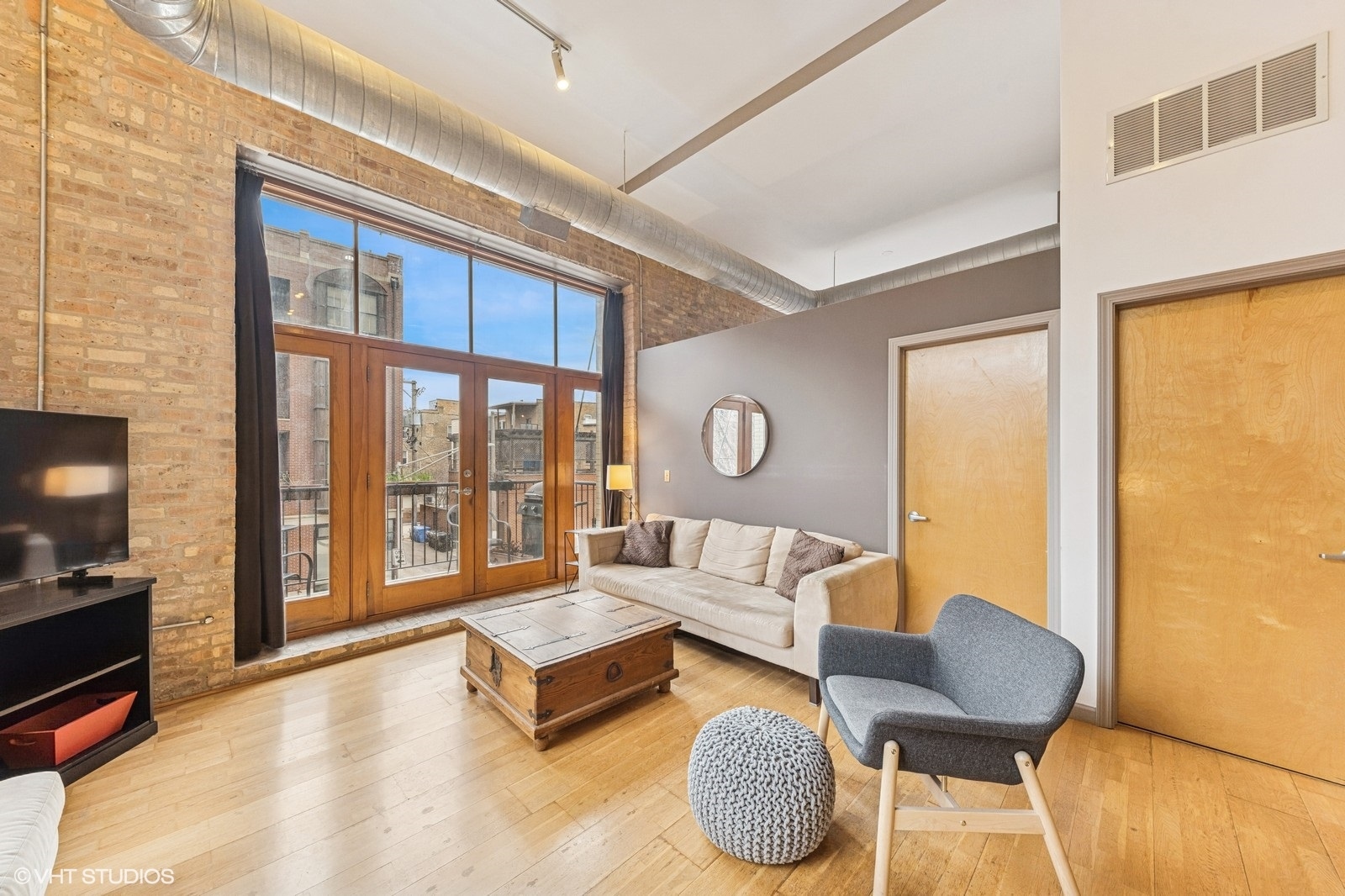 2101 West Rice Street, Unit 204 Chicago, IL 60622 - Photo 3 of 14 a living room with furniture and a floor to ceiling window