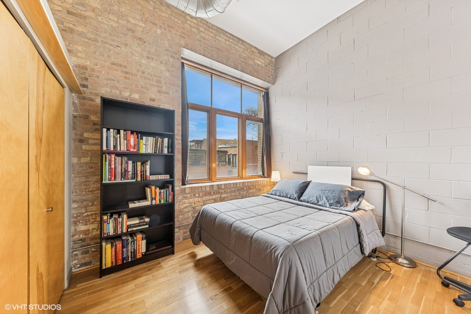 2101 West Rice Street, Unit 204 Chicago, IL 60622 - Photo 10 of 14 a bedroom with a bed and a flat tv screen