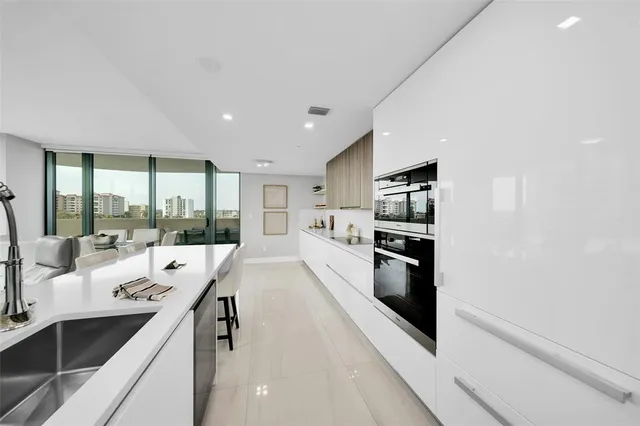 a dining room with furniture and a floor to ceiling window