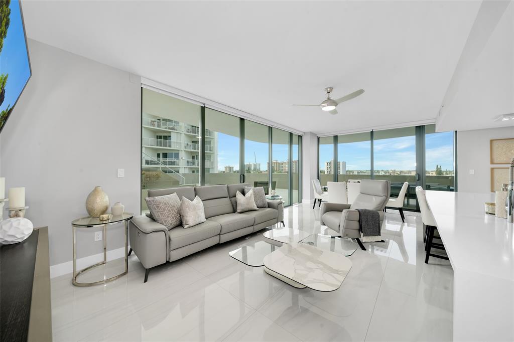 730 North Ocean Boulevard, Unit 405 Pompano Beach, FL 33062 - Photo 7 of 47 a living room with furniture and a large window