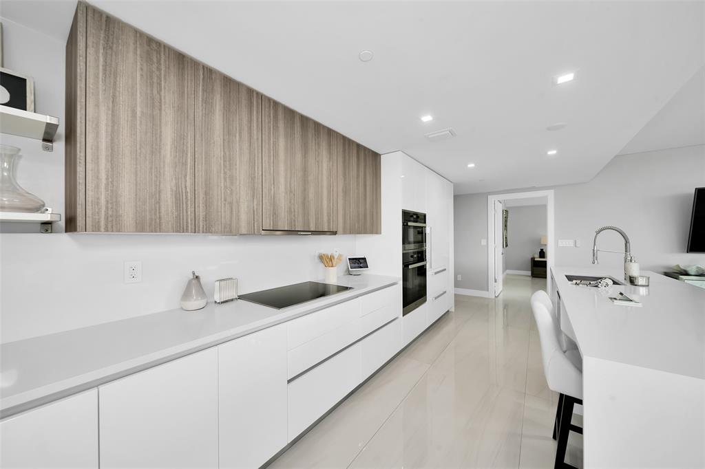 730 North Ocean Boulevard, Unit 405 Pompano Beach, FL 33062 - Photo 9 of 47 a view of a kitchen with a sink and dishwasher
