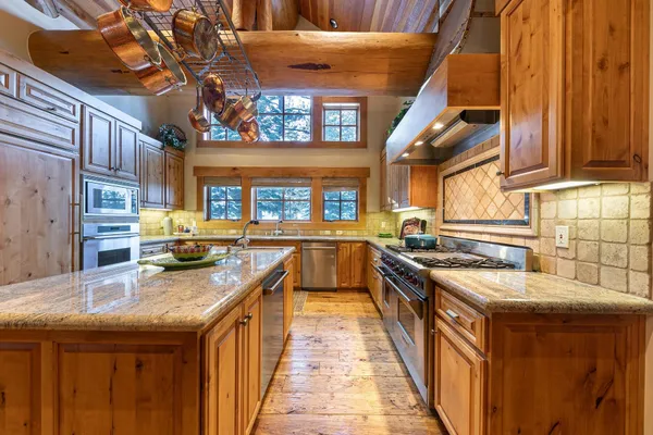 a bathroom with a granite countertop sink a toilet and shower