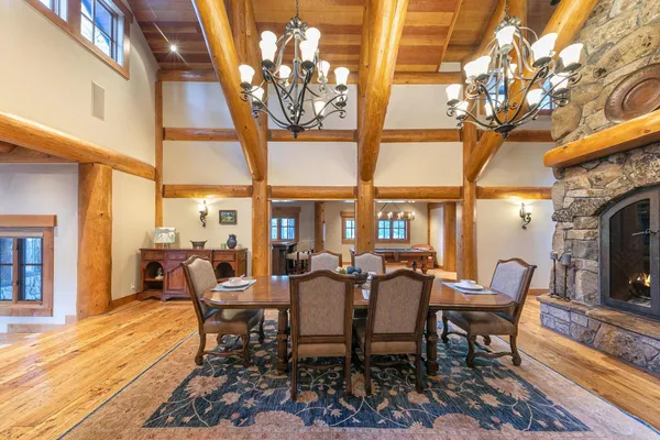 a dining room with furniture a chandelier and wooden floor