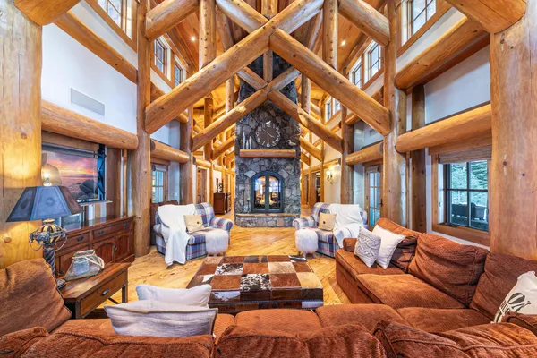 a dining room with furniture a chandelier and wooden floor
