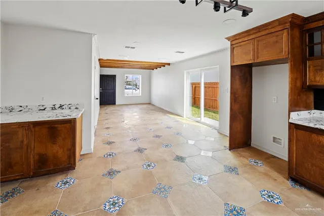 a kitchen with stainless steel appliances granite countertop a refrigerator and a stove top oven