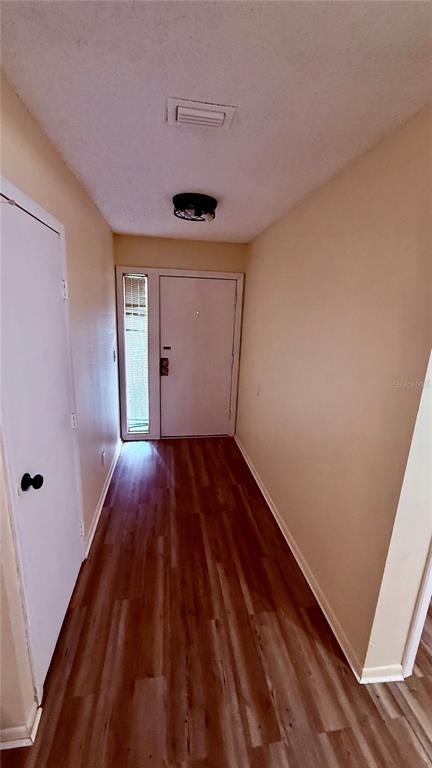 6519 West Newberry Road, Unit 206 Gainesville, FL 32605 - Photo 14 of 14 a view of hallway with a large window and wooden floor