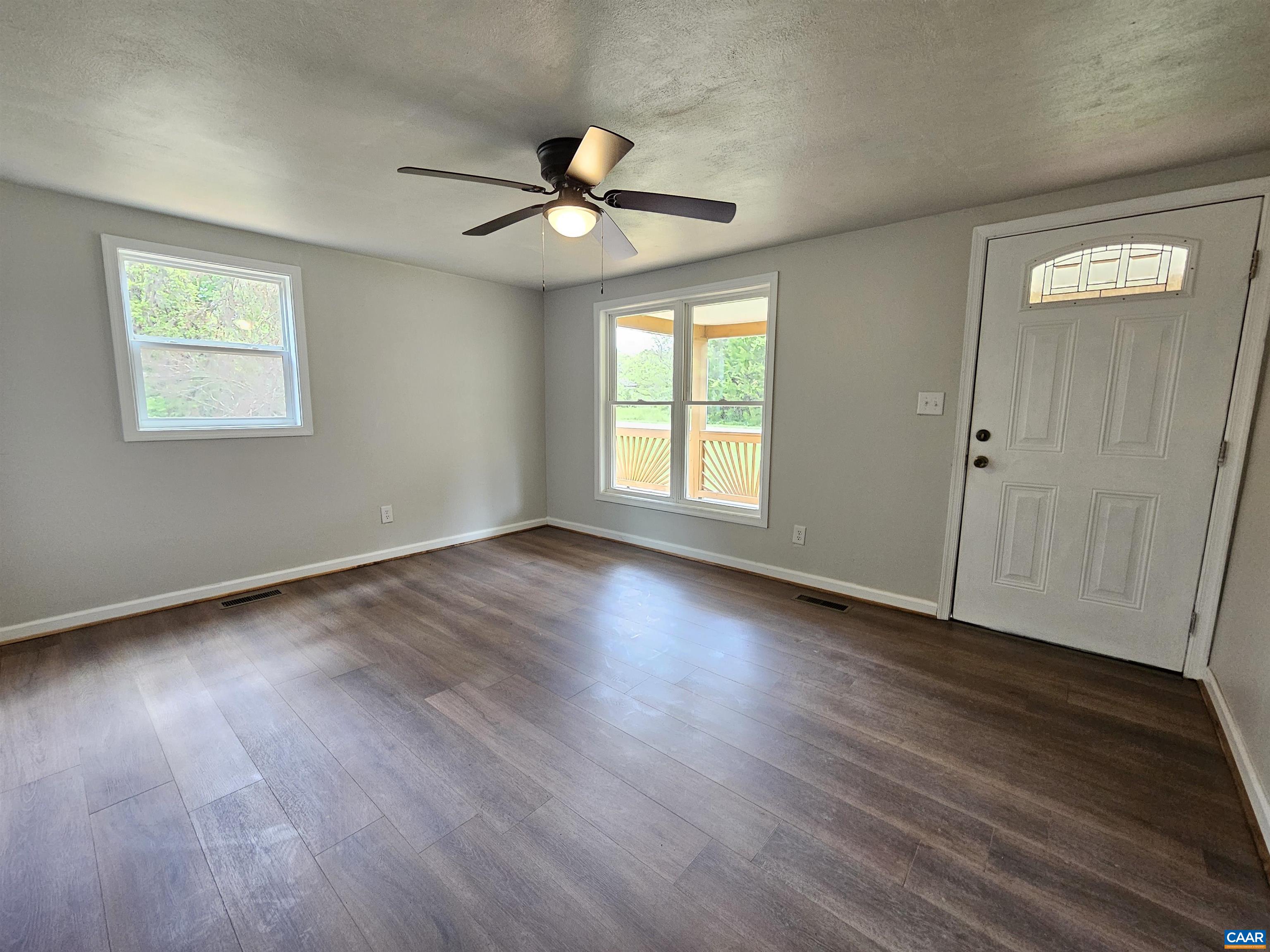 5290 Dixie Hill Road Buckingham, VA 23921 - Photo 9 of 24 a view of an empty room with wooden floor and a window