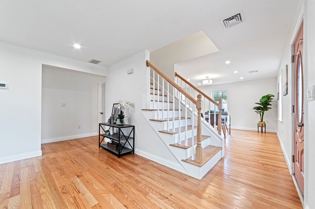 40 Howe Street Quincy, MA 02169 - Photo 13 of 42 a hallway with wooden floor and a potted plant