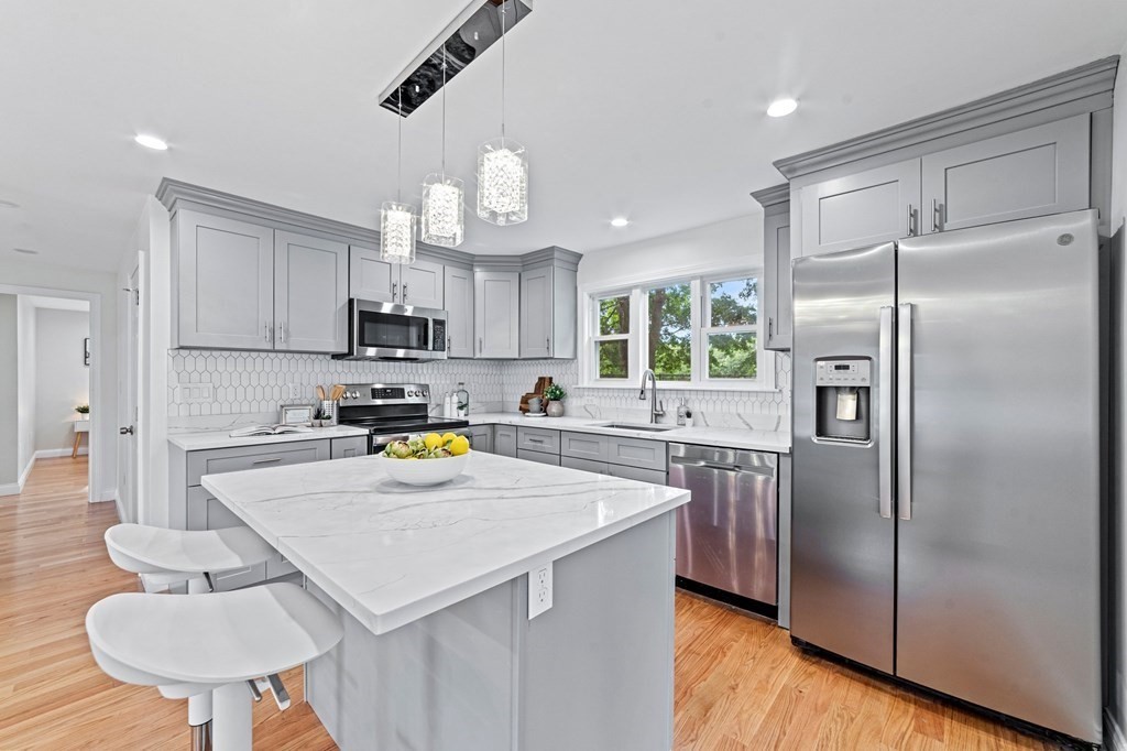 40 Howe Street Quincy, MA 02169 - Photo 18 of 42 a kitchen with a refrigerator a stove a sink and a refrigerator