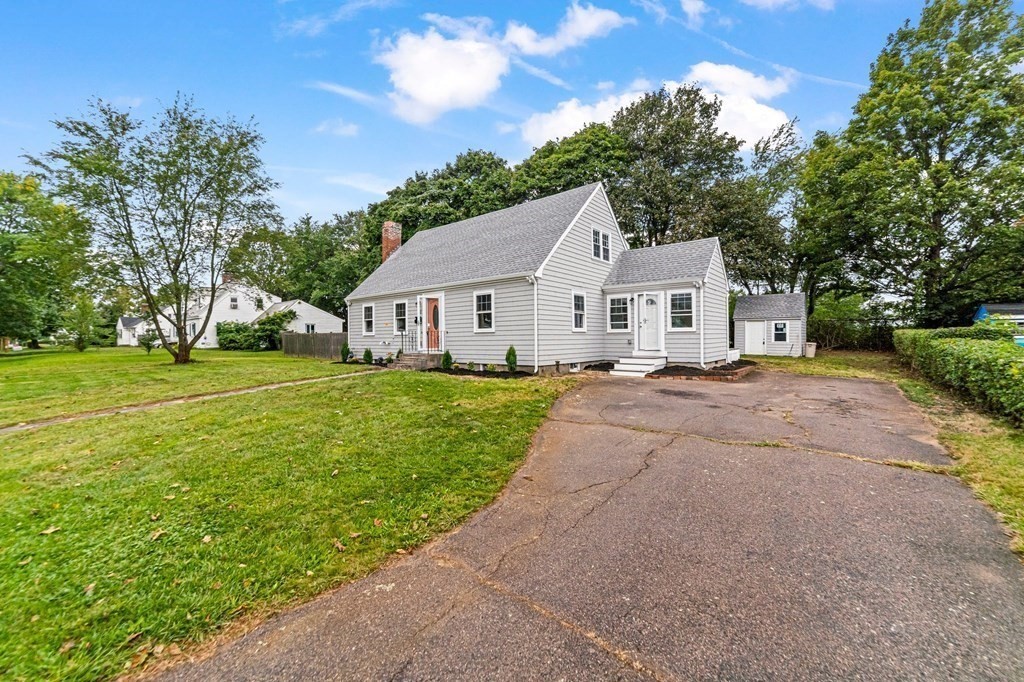 40 Howe Street Quincy, MA 02169 - Photo 2 of 42 a view of a house with a big yard and large trees