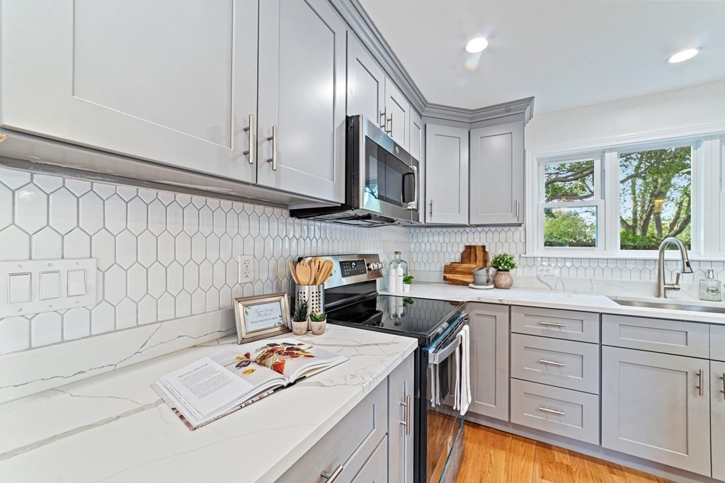 40 Howe Street Quincy, MA 02169 - Photo 21 of 42 a kitchen with stainless steel appliances granite countertop a sink stove and cabinets