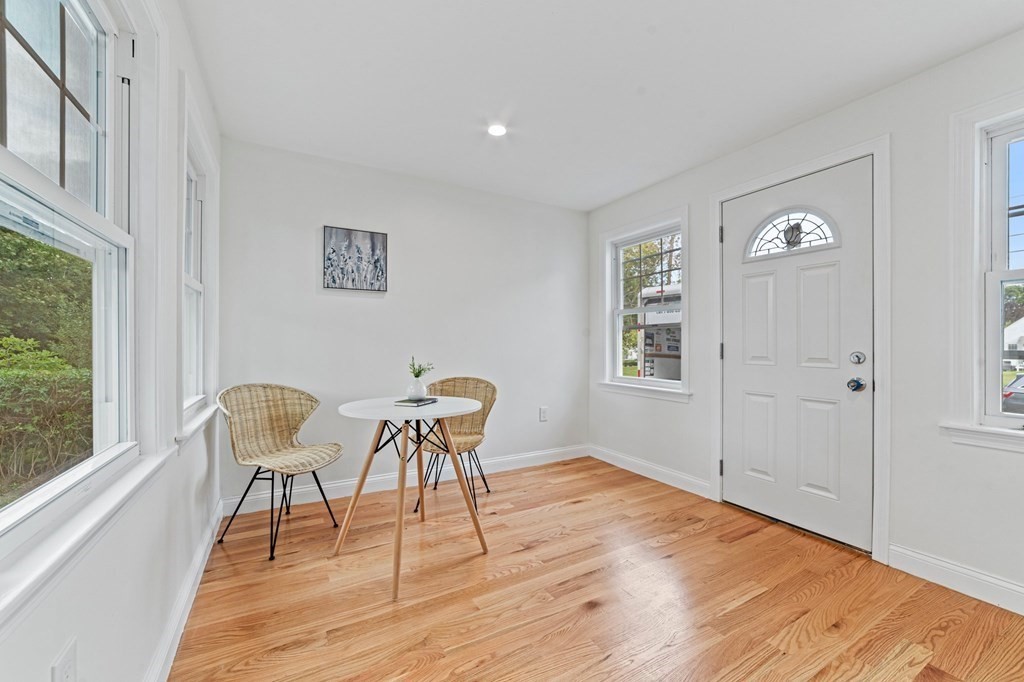 40 Howe Street Quincy, MA 02169 - Photo 22 of 42 a dining room with wooden floor and a window