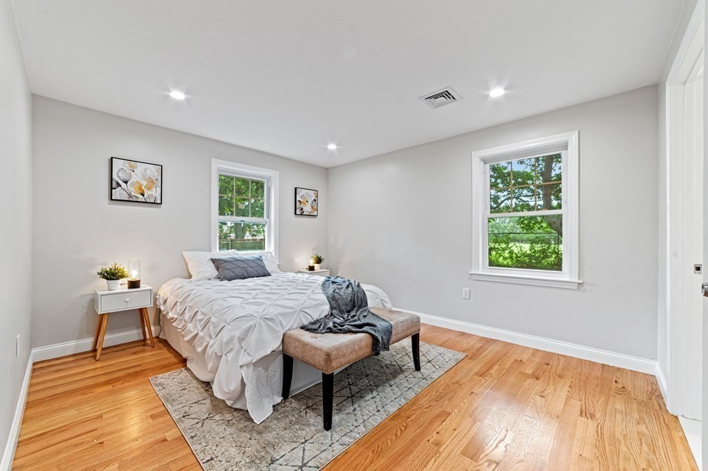 40 Howe Street Quincy, MA 02169 - Photo 23 of 42 a bedroom with a bed and wooden floor