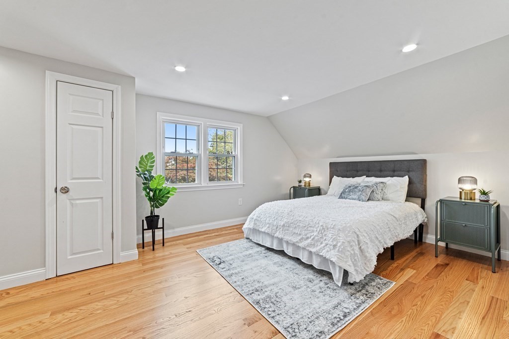 40 Howe Street Quincy, MA 02169 - Photo 30 of 42 a spacious bedroom with a bed table and a window