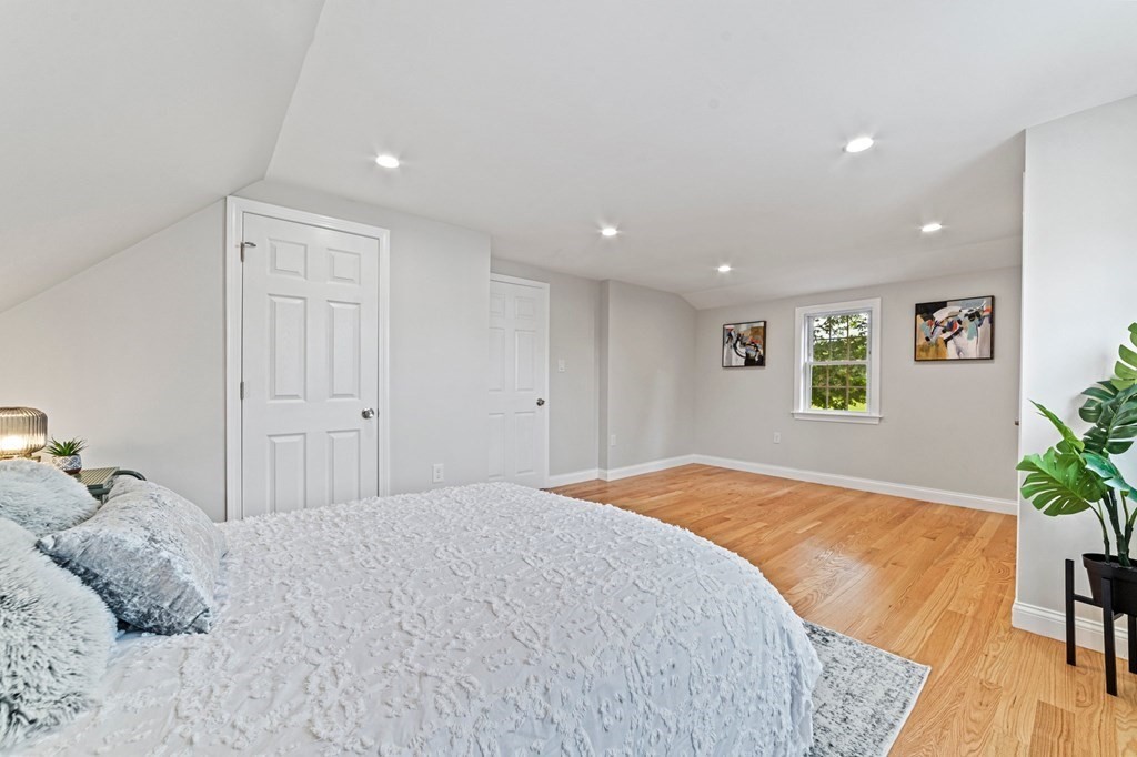 40 Howe Street Quincy, MA 02169 - Photo 31 of 42 a bedroom with a bed and a potted plant