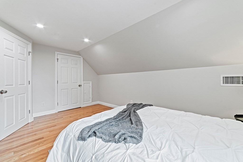 40 Howe Street Quincy, MA 02169 - Photo 33 of 42 a bedroom with a bed and a painting