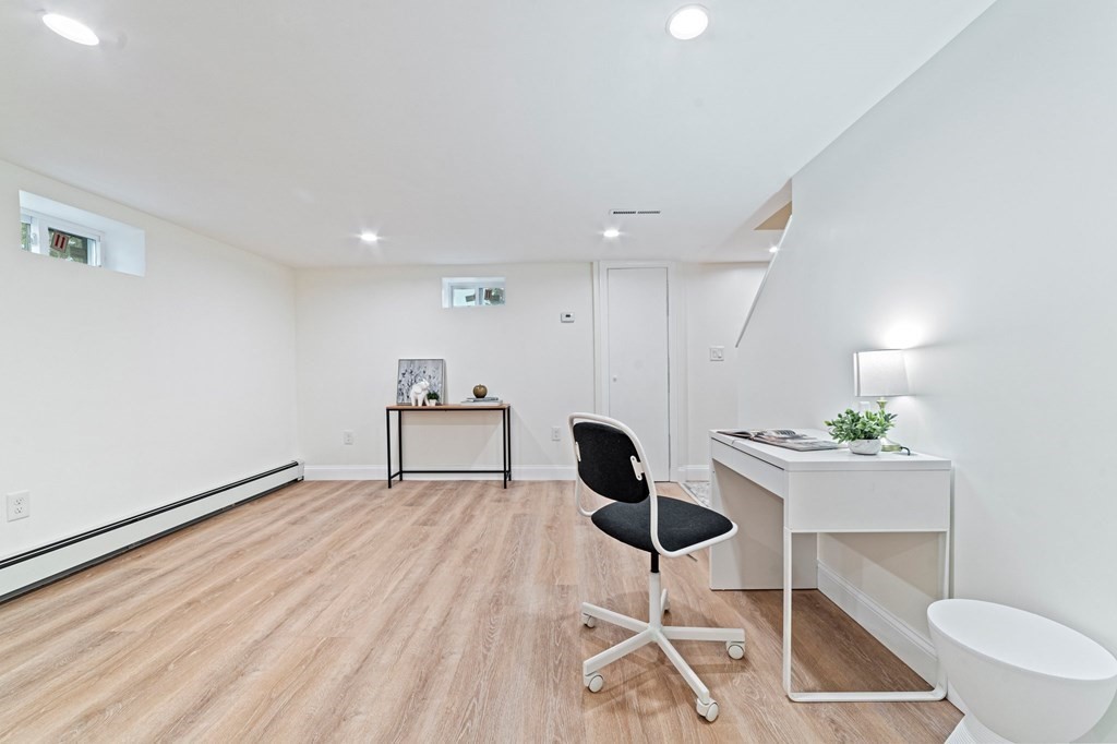 40 Howe Street Quincy, MA 02169 - Photo 37 of 42 a workspace with furniture and a potted plant