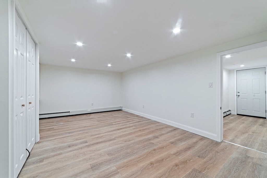 40 Howe Street Quincy, MA 02169 - Photo 38 of 42 a view of an empty room with wooden floor and a window