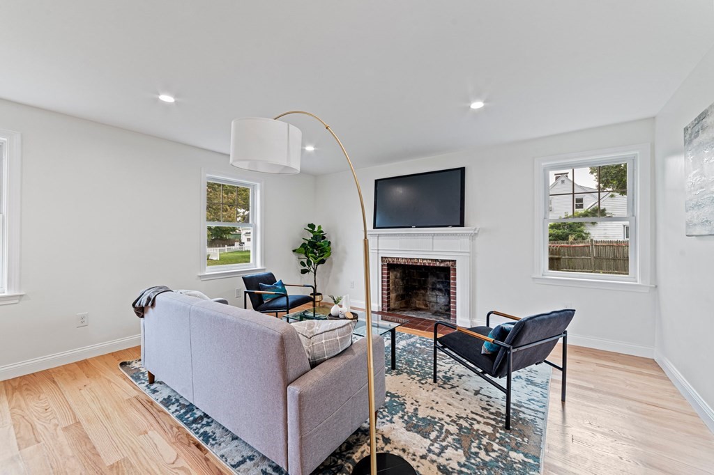 40 Howe Street Quincy, MA 02169 - Photo 9 of 42 a living room with furniture and a fireplace